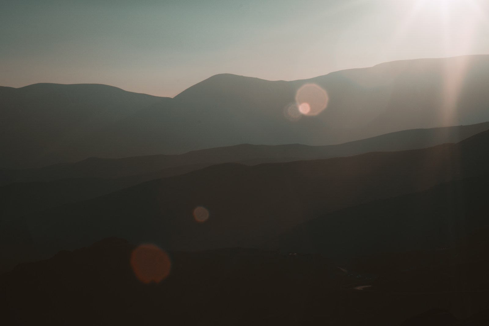 The sun is shining brightly over the mountains